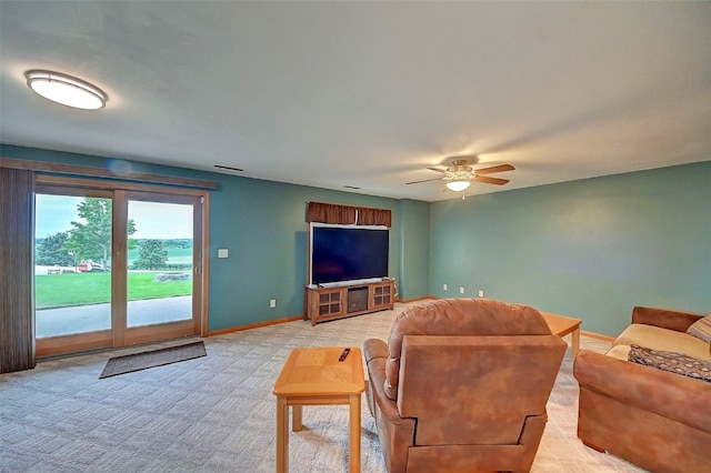 carpeted living room with ceiling fan