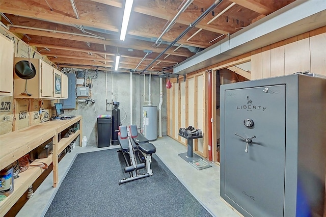 exercise area with gas water heater and a workshop area