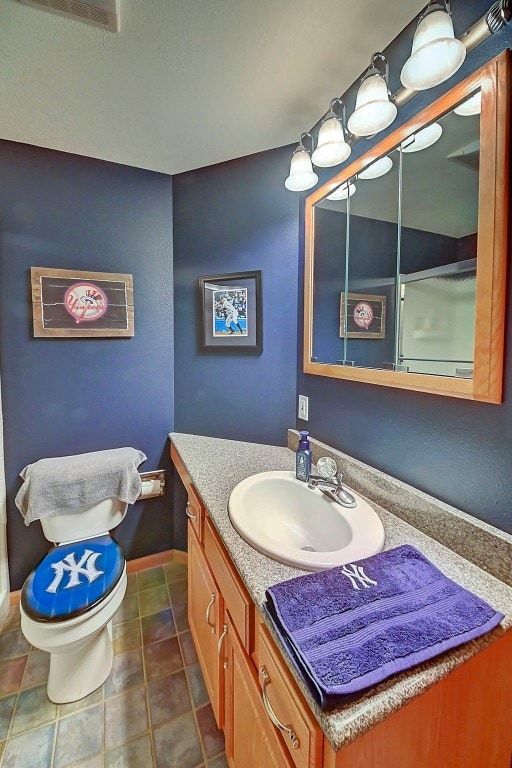 bathroom with vanity, tile patterned floors, and toilet