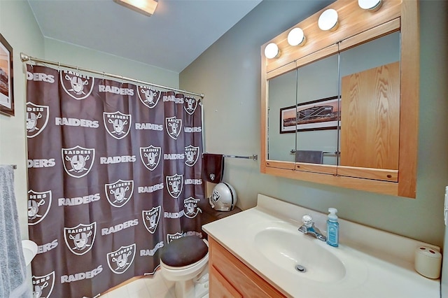 bathroom featuring walk in shower, vanity, and toilet