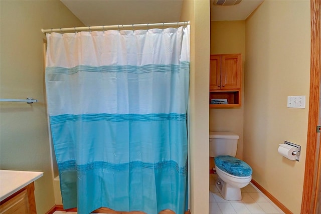 bathroom featuring tile patterned floors, toilet, and vanity