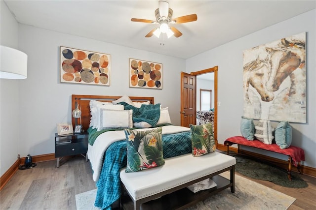 bedroom featuring hardwood / wood-style floors and ceiling fan