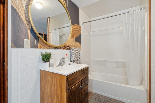 bathroom with tasteful backsplash, shower / tub combo with curtain, vanity, and tile walls