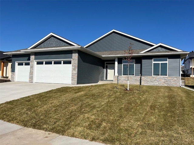 view of front of home with a front lawn and a garage