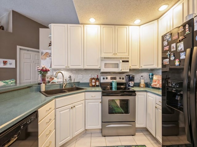 kitchen featuring light tile patterned floors, black appliances, a sink, and white cabinets