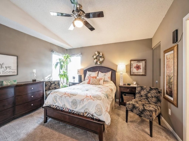 bedroom with carpet floors, vaulted ceiling, a textured ceiling, ceiling fan, and baseboards