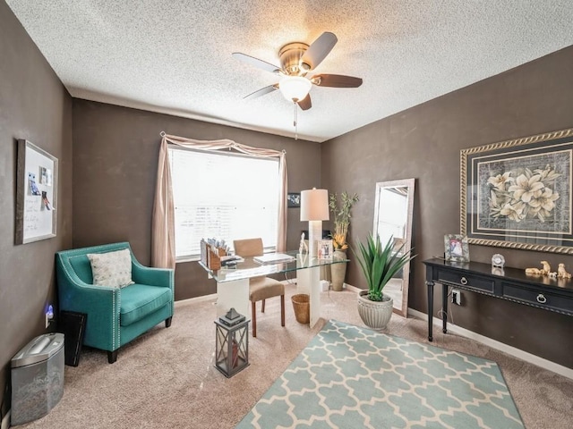 sitting room featuring a textured ceiling, ceiling fan, carpet, and baseboards