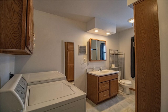 bathroom featuring washer and dryer, vanity, and toilet