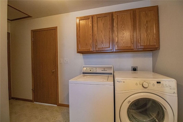 washroom featuring cabinets and independent washer and dryer