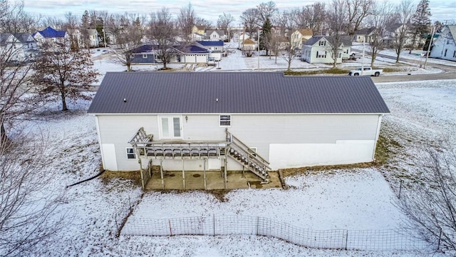 view of snow covered rear of property