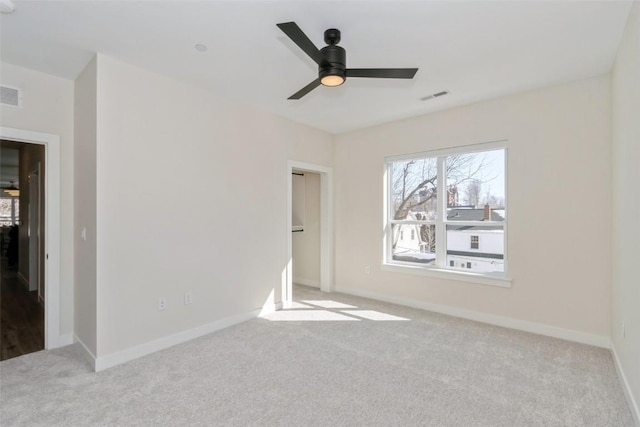 unfurnished bedroom featuring baseboards, visible vents, and light colored carpet