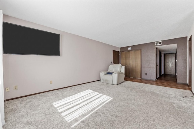 unfurnished bedroom featuring a closet, carpet, visible vents, and baseboards