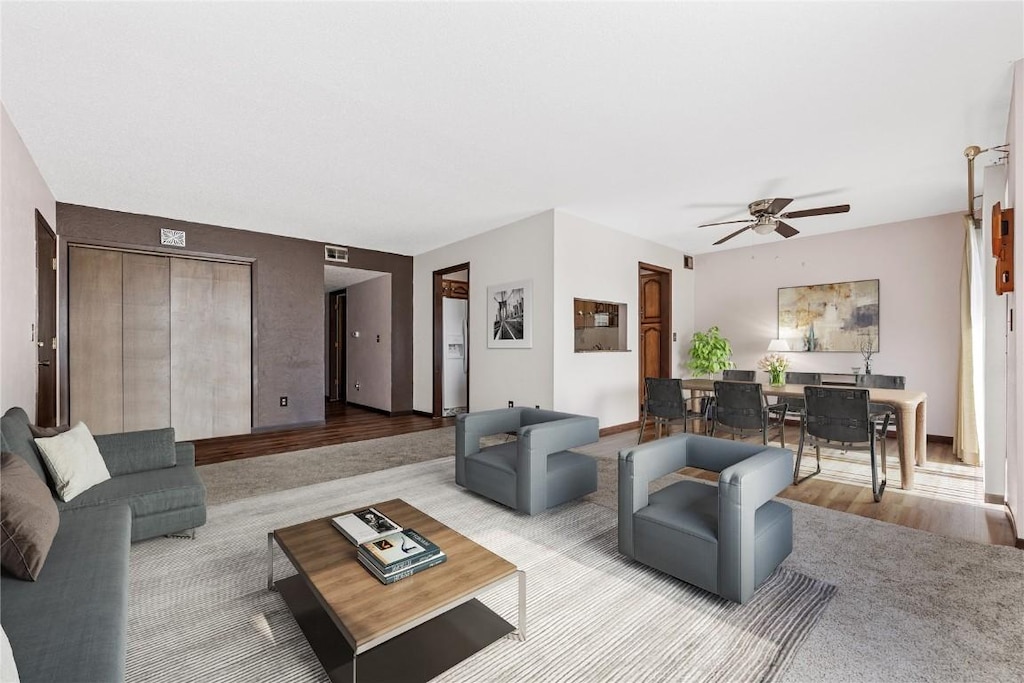 living room with ceiling fan and light wood-style flooring