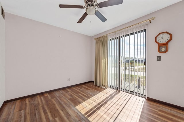 unfurnished room with ceiling fan, wood finished floors, and baseboards