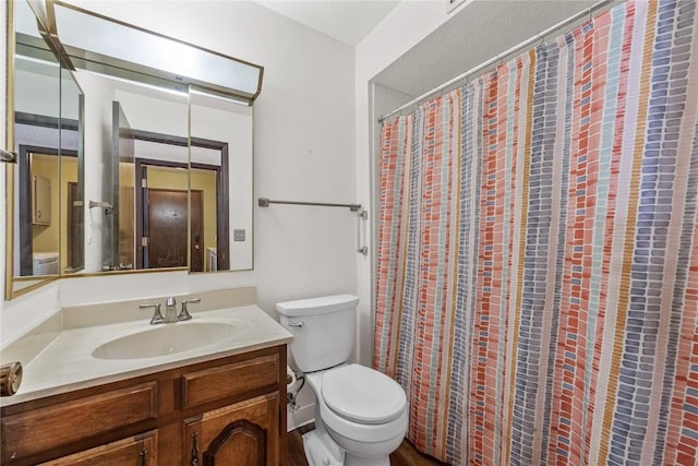 full bathroom featuring a shower with shower curtain, vanity, and toilet