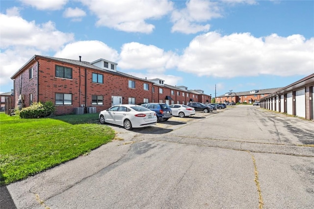 uncovered parking lot with a residential view and community garages