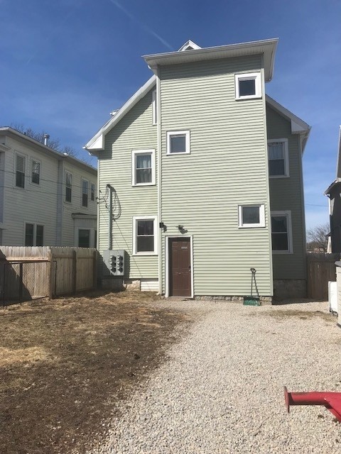 back of house with fence