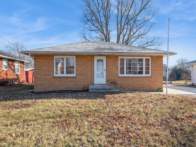 bungalow with a front yard and brick siding