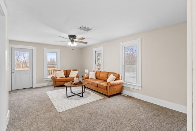 living room with carpet flooring, plenty of natural light, and ceiling fan