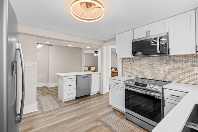 kitchen featuring tasteful backsplash, white cabinetry, ceiling fan, and stainless steel appliances