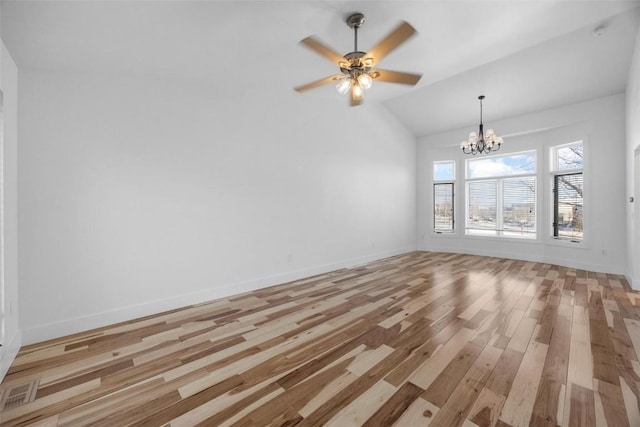 unfurnished living room featuring ceiling fan with notable chandelier, light hardwood / wood-style floors, and vaulted ceiling