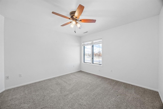 carpeted spare room featuring ceiling fan