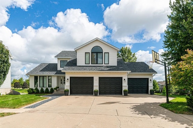 view of front of home with a garage and a front lawn