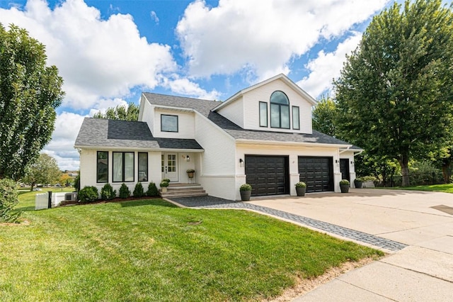 view of front of property with a front lawn and a garage