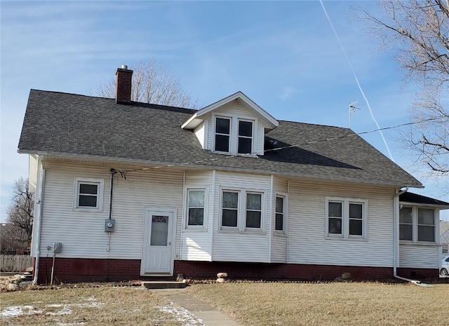 rear view of property featuring a yard