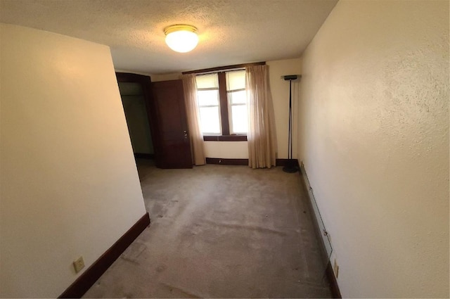 empty room featuring carpet flooring and a textured ceiling