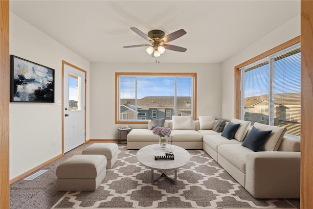 living room with carpet floors, a wealth of natural light, and ceiling fan