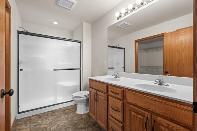 bathroom featuring vanity, toilet, and an enclosed shower