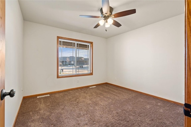 carpeted spare room featuring ceiling fan