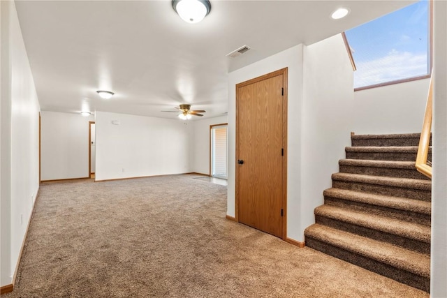 interior space with ceiling fan and carpet floors