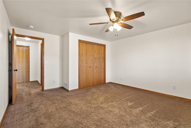 unfurnished bedroom with carpet floors, a closet, and ceiling fan