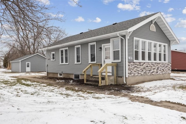 view of snow covered rear of property