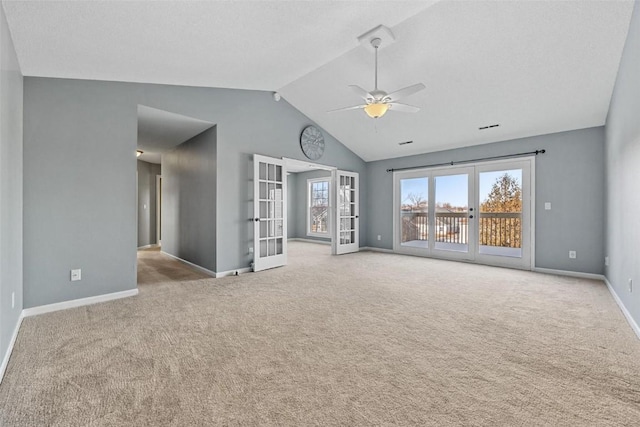 unfurnished living room featuring french doors, light colored carpet, ceiling fan, and lofted ceiling