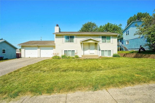 split foyer home featuring a garage and a front yard