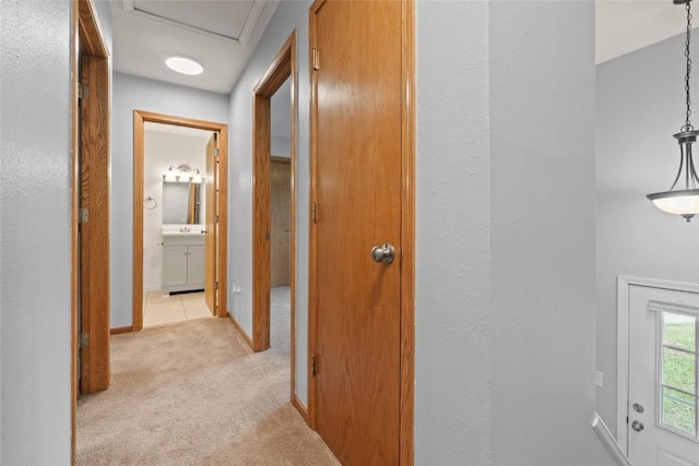 hallway featuring light colored carpet