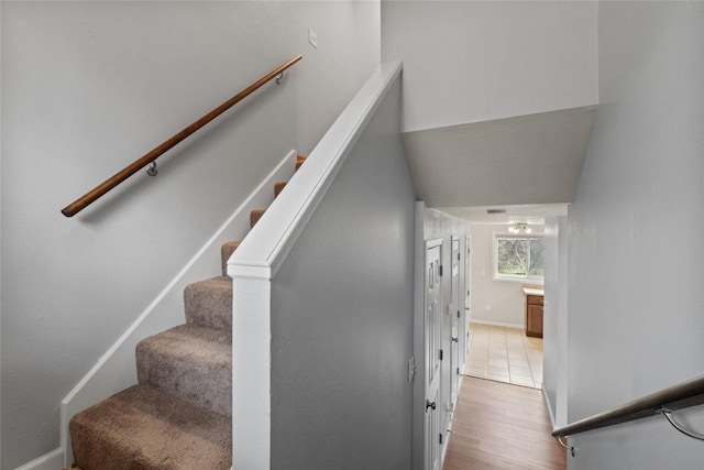 stairs with hardwood / wood-style floors