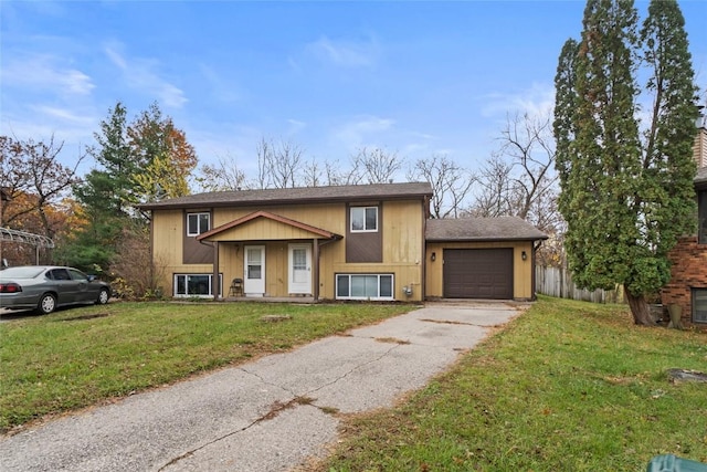 raised ranch with a garage and a front lawn