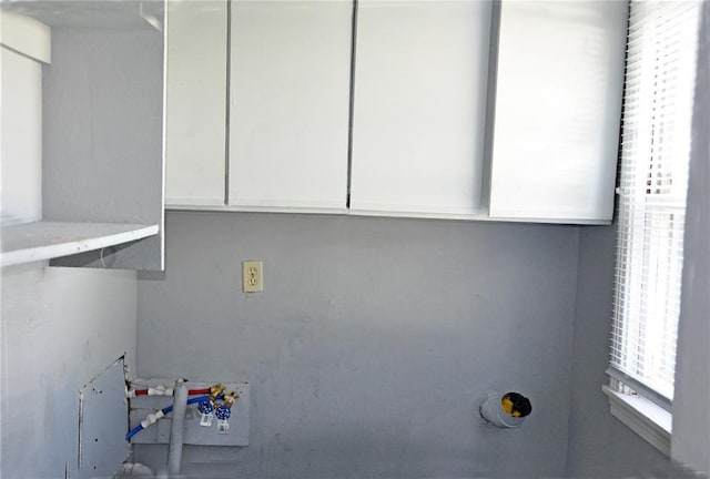 clothes washing area featuring cabinets and washer hookup