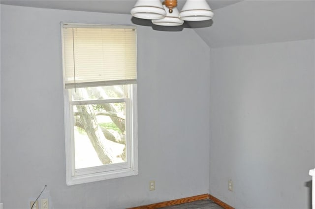 additional living space with a chandelier