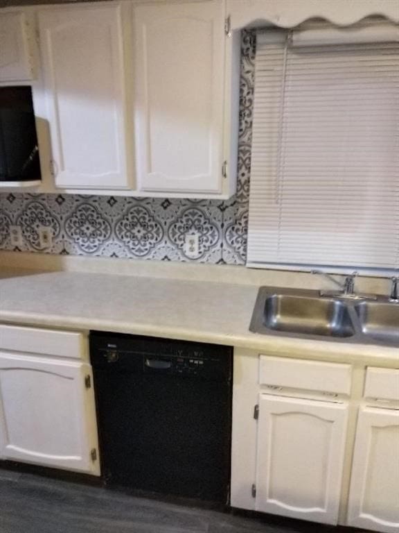 kitchen featuring dishwasher, white cabinetry, and sink