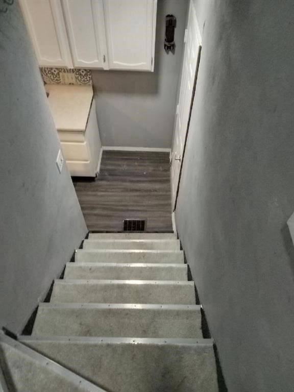 stairs featuring wood-type flooring