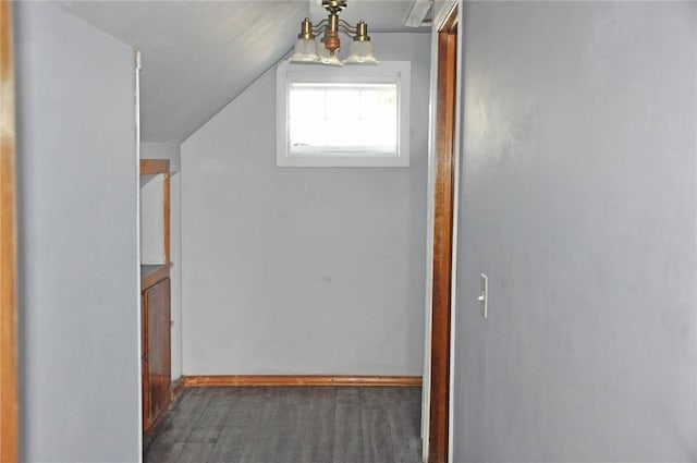 hall featuring an inviting chandelier and vaulted ceiling