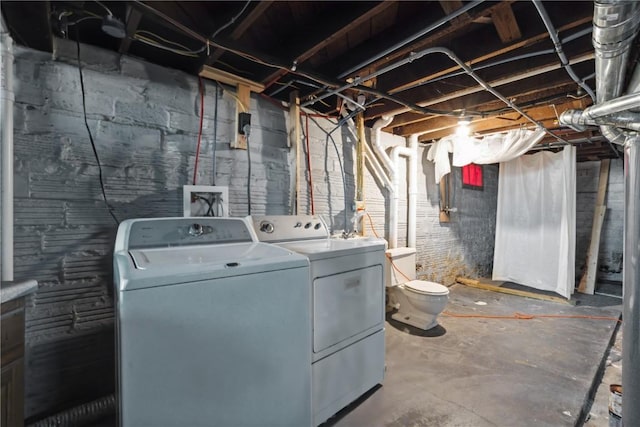 basement featuring washing machine and clothes dryer