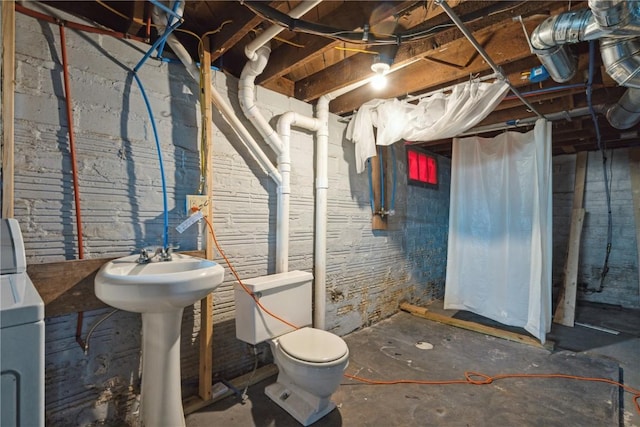 basement featuring washer / clothes dryer and sink