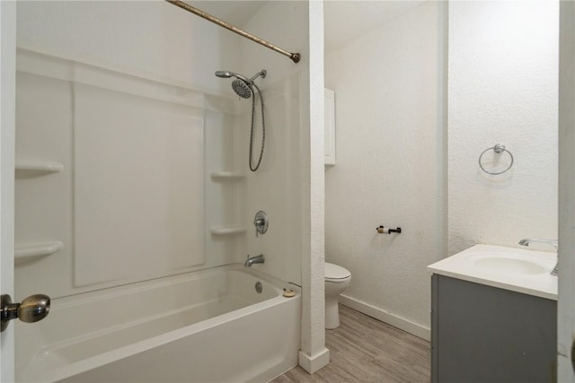 full bathroom with shower / bath combination, vanity, hardwood / wood-style flooring, and toilet