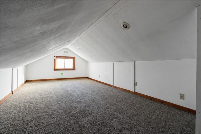 bonus room with carpet floors and vaulted ceiling